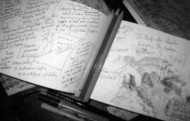 black and white blurry photograph of an open notebook